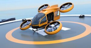 Orange self-driving passenger drone takeoff from helipad